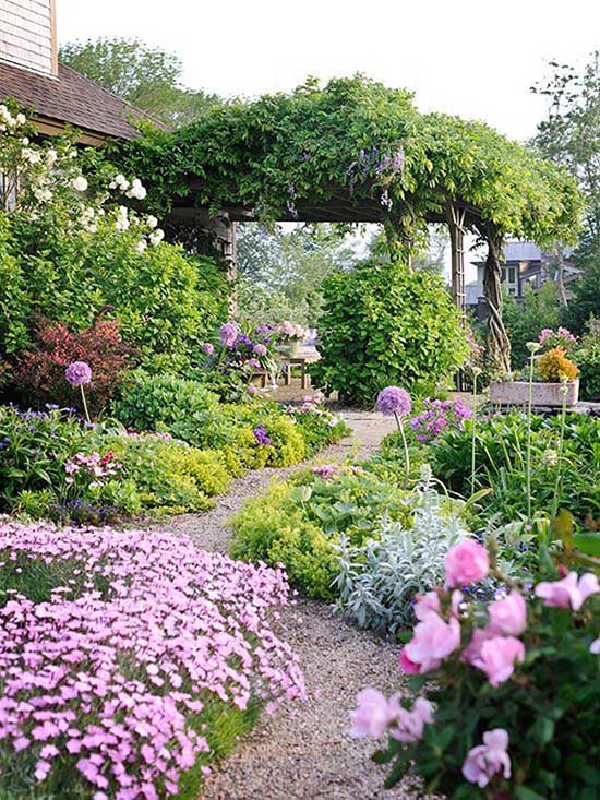 Flower bed around pathway with flowers and pebbles #flowerbed #gardens #decorhomeideas