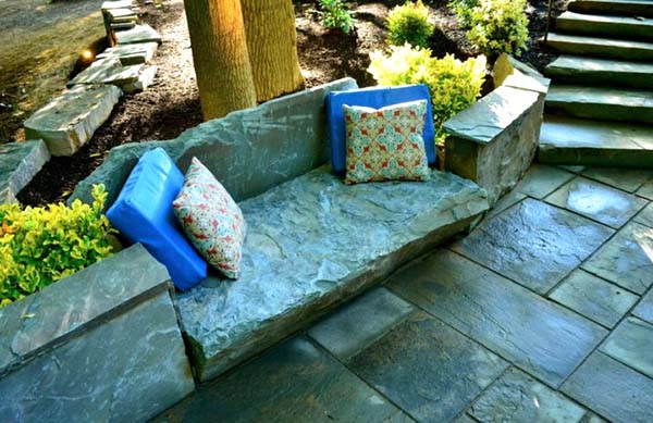 Garden bench made of stone with throw pillows #rockbench #gardens #gardening #gardenideas #gardeningtips #decorhomeideas