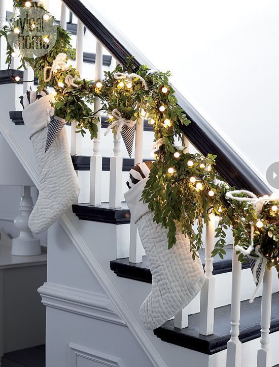 Christmas staircase decorated with socks and lights #Christmasdecor #staircase #stairs #stairway #Christmas #decorhomeideas