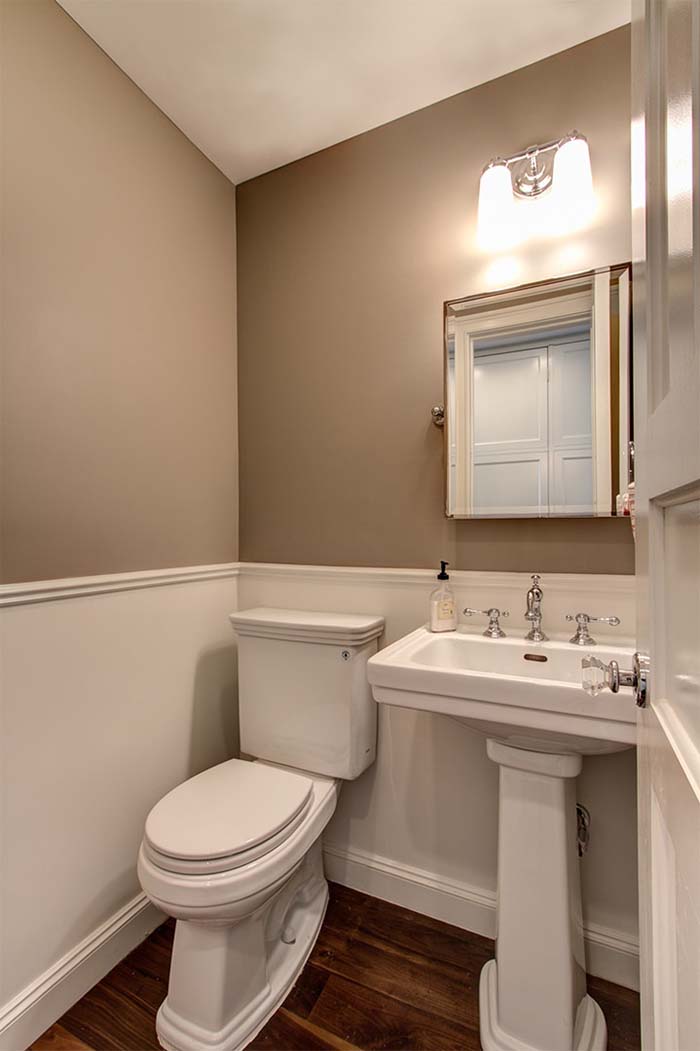 Brown Painted Bathroom With Wainscoting Design