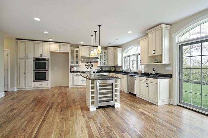 Open plan kitchen with antique white cabinets