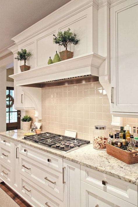 Traditional White Kitchen Cabinets paired with granite countertops and a light grey tile backsplash