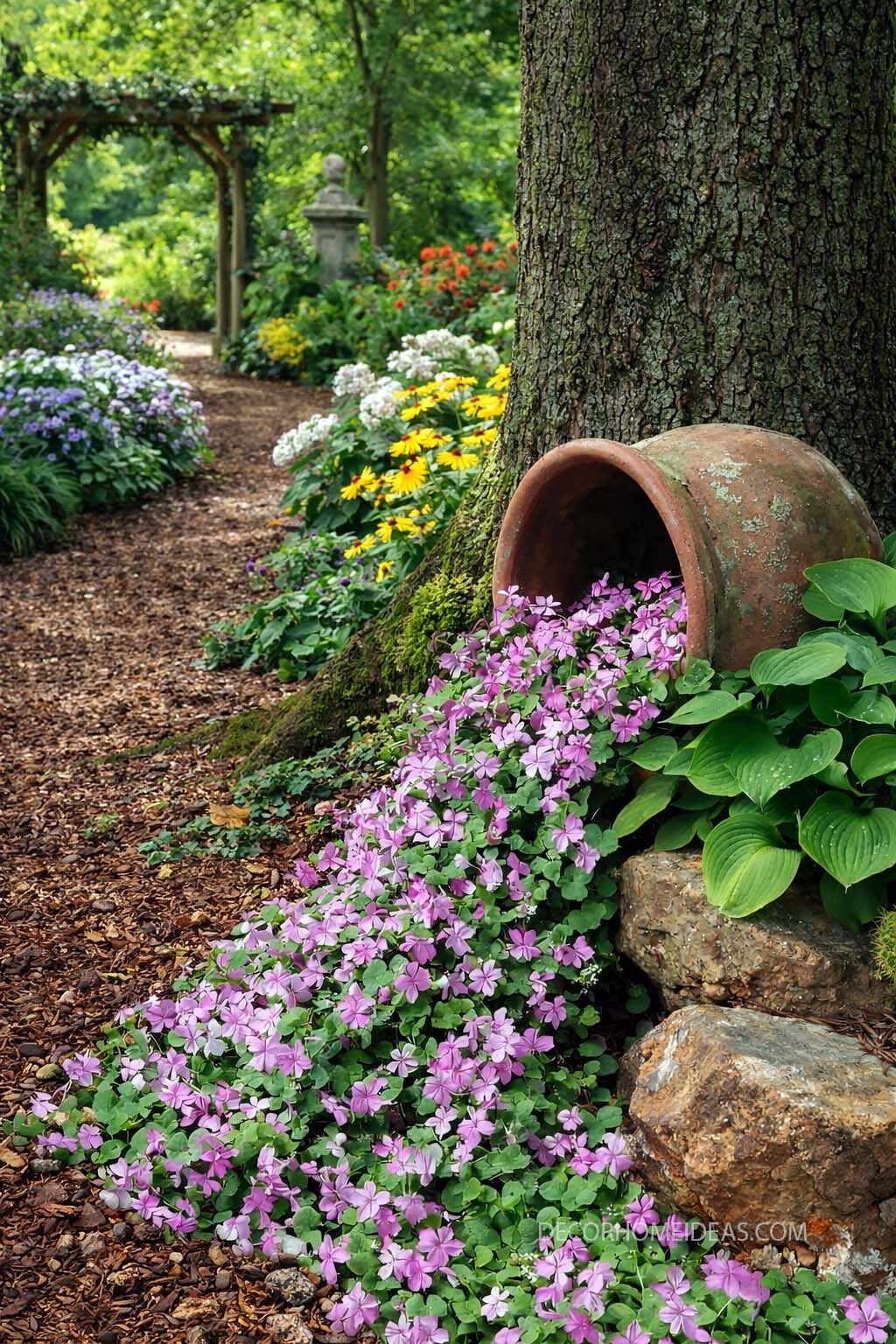Spilled Flower Pot Flower Bed Idea Around a Tree