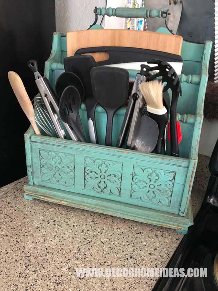 Turquoise Magazine Holder Turned Into storage for kitchen accessories, utensils and cutting boards #farmhouse #farmhousedecor #storage #organization #decorhomeideas
