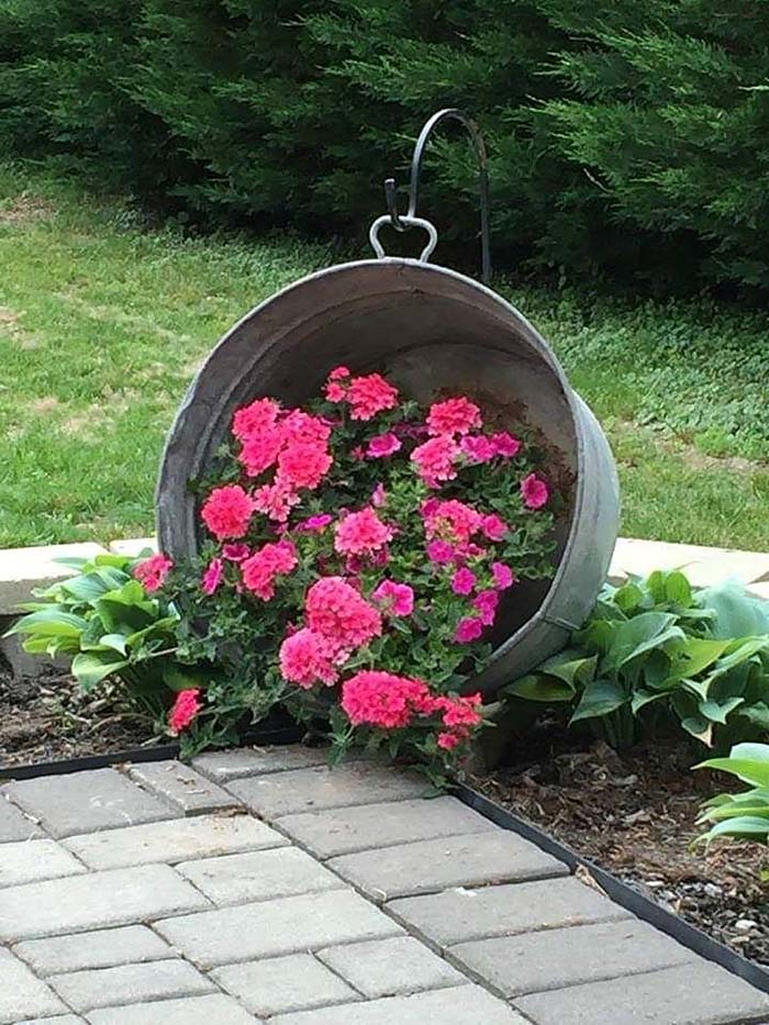 Metal Bucket With Flowers Corner Garden. Put an old metal bucket with some small flowers in it at the corner of your pathway. #corner #garden #flowers #bucket #decorhomeideas