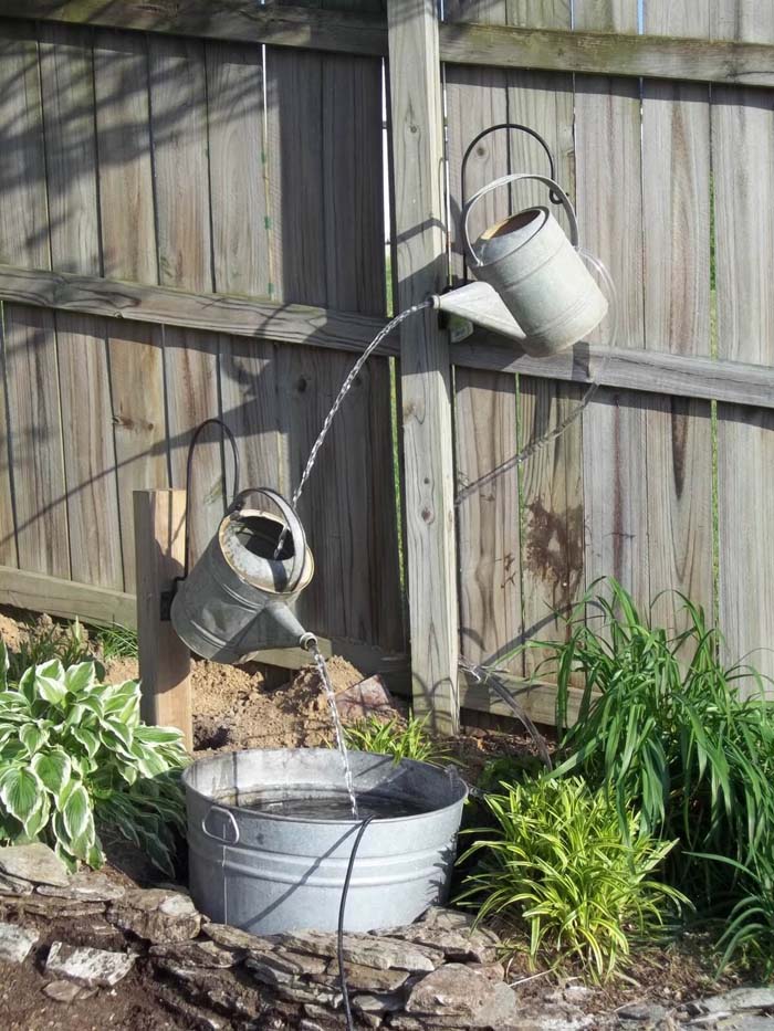 Whimsical Floating Watering Cans Water Feature #diy #waterfeature #backyard #garden #decorhomeideas