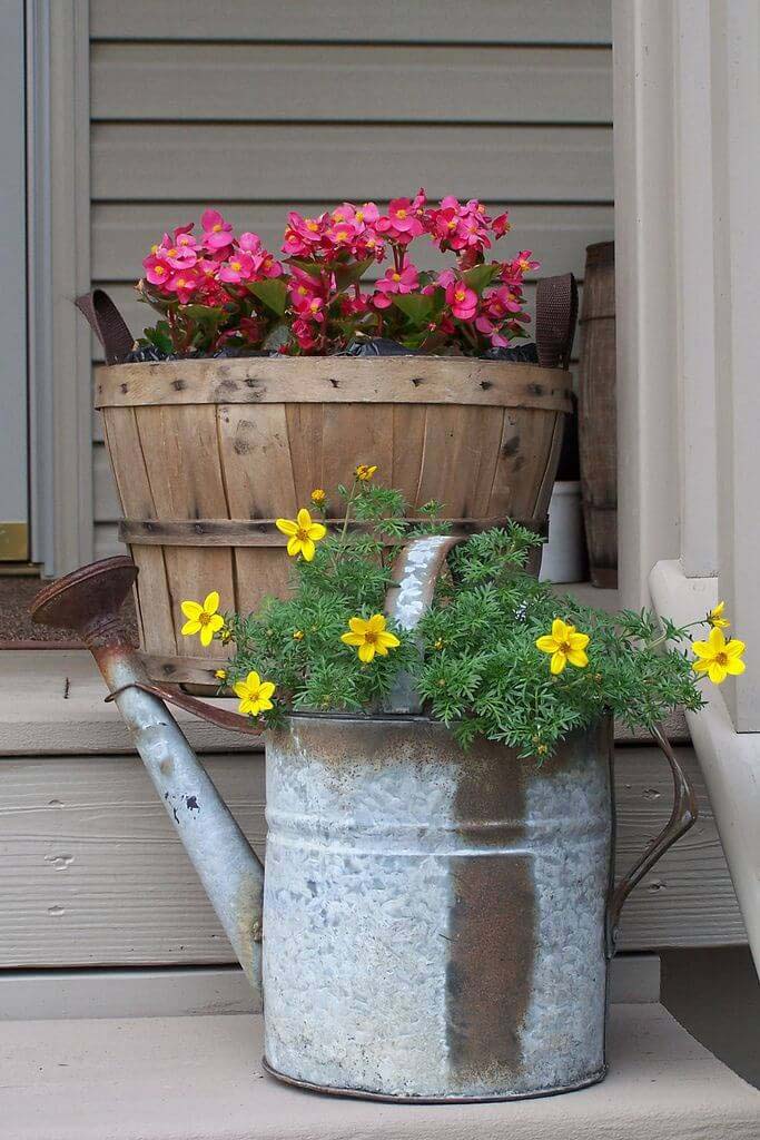 Flowers in a Barrel and Watering Cans #diy #planter #porch #decorhomeideas