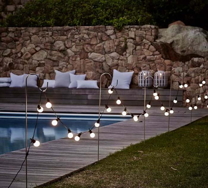 Globe Lights Hung On Hooks by the Pool #lighting #landscape #garden #decorhomeideas
