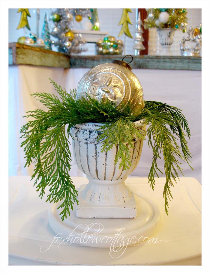 Oversized Christmas Ball in a Nest of Greenery #Christmas #urns #decorations #decorhomeideas