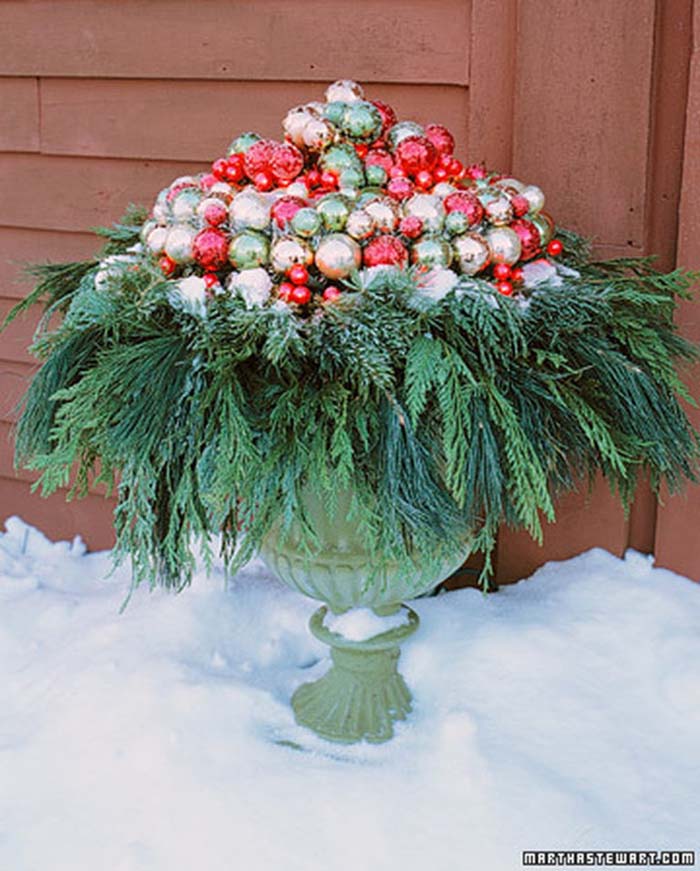 Red, Green, and Gold Baubles in a Bed of Greens #Christmas #urns #decorations #decorhomeideas