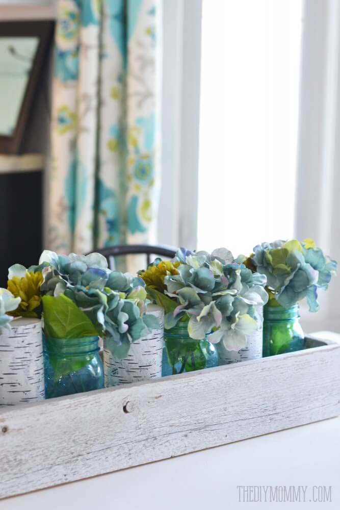 Blue Hydrangea Arrangement in Colored Bottles #farmhouse #springdecor #decorhomeideas