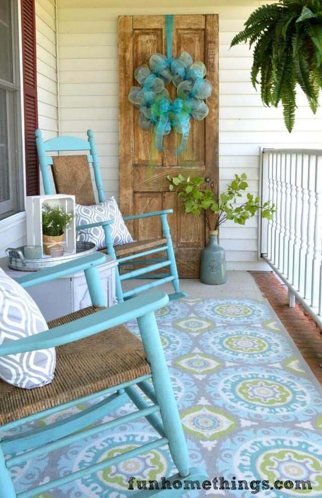 Turquoise Rocking Chairs, Patterned Rug, Billowy Wreath #rustic #springdecor #porch #decorhomeideas