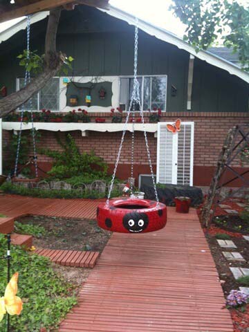 A Ladybug Tire Swing with a Smile #backyardkidsgames #diybackyardgames #decorhomeideas