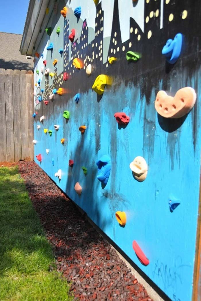 A Rock Climbing Wall with Unique Artwork #backyardkidsgames #diybackyardgames #decorhomeideas