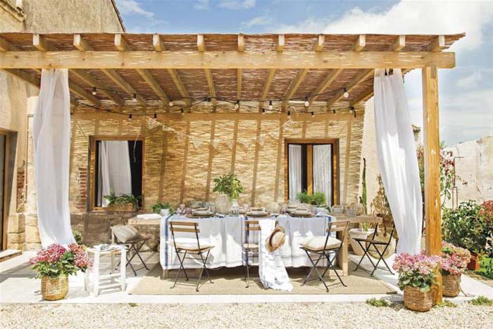 Rustic Covered Patio with White Curtains #rusticpatioideas #rusticpatio #decorhomeideas