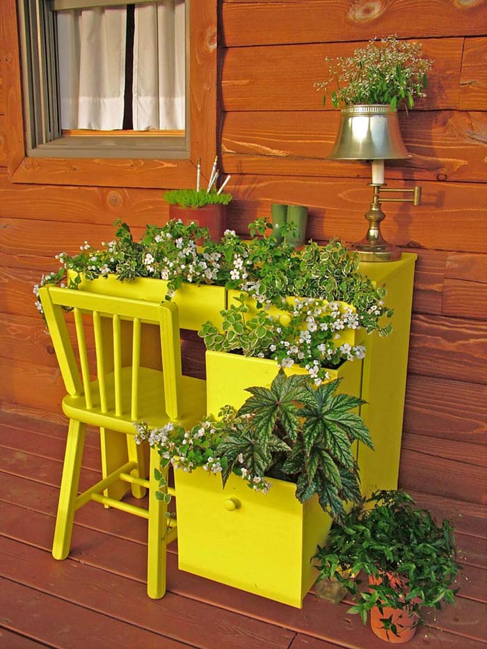Bright Yellow Desk with Greens and Flowers #repurposedplanter #repurposedcontainer #decorhomeideas