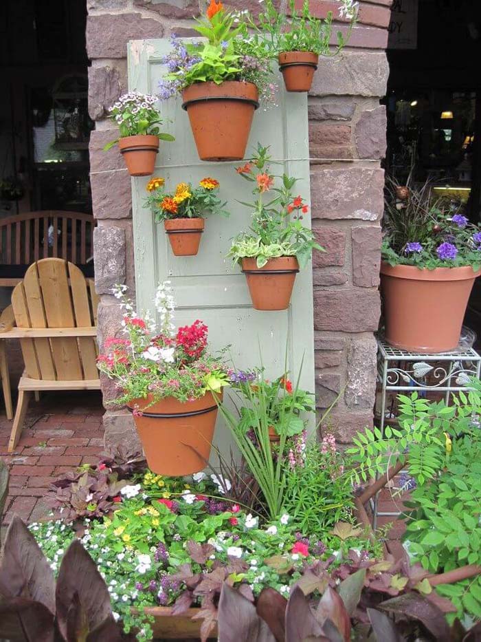 Terra Cotta Pots Hung From a Door #repurposedplanter #repurposedcontainer #decorhomeideas