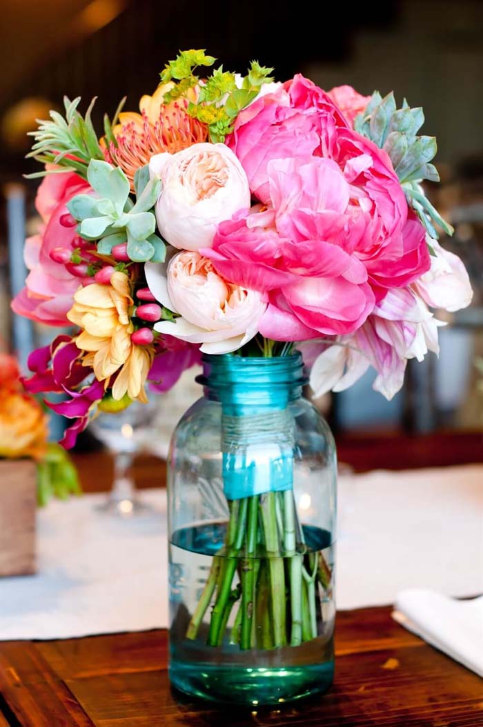 Bridesmaid's Bouquet Resting in Mason Jar #flowerarrangementsideas #flowerarrangement #decorhomeideas