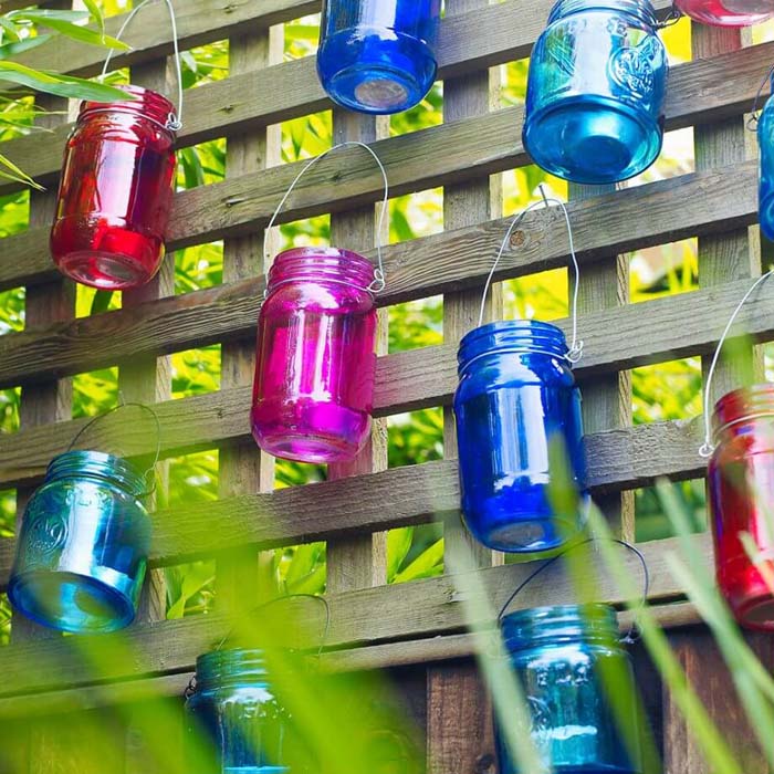 Multicolored Mason Jars with Wire Hangers #gardenfencedecoration #decorhomeideas