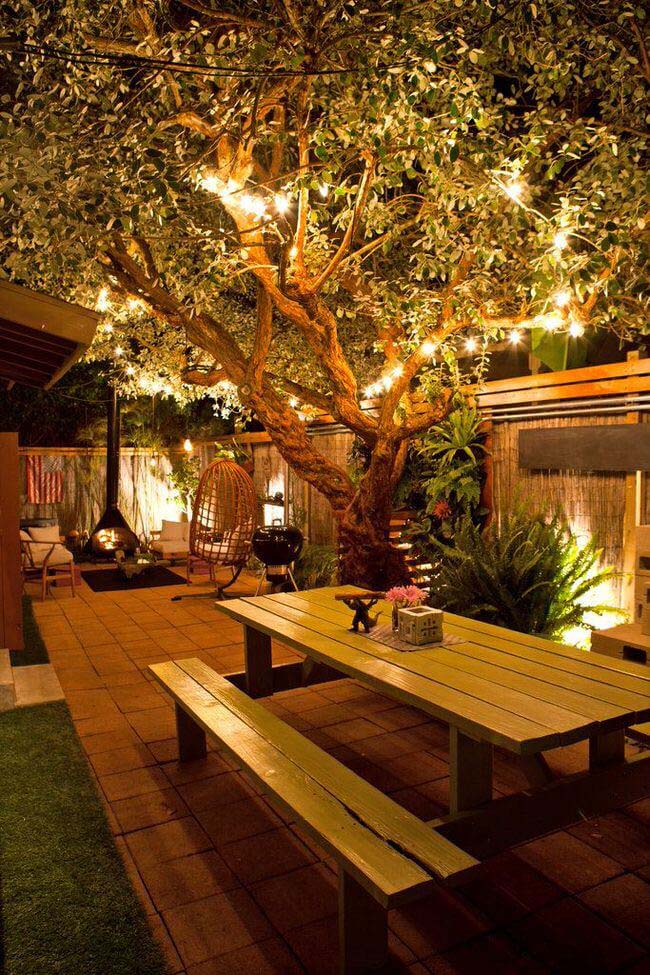 Outdoor Seating Under Tree String Lights #backyardlightingideas #decorhomeideas