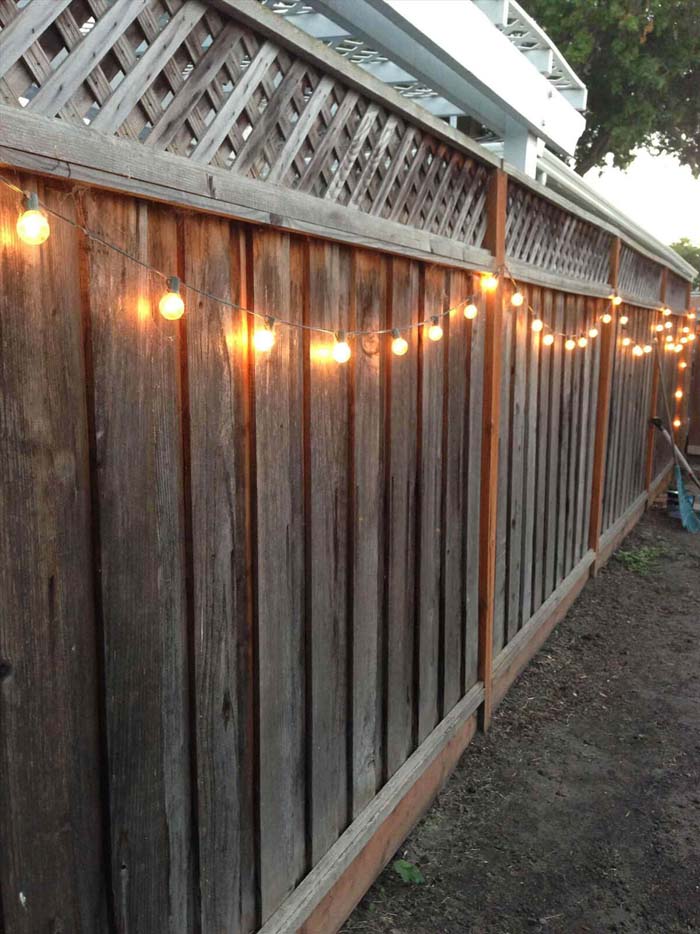 String Pretty Globe Lights Along Your Fence #gardenfencedecoration #decorhomeideas