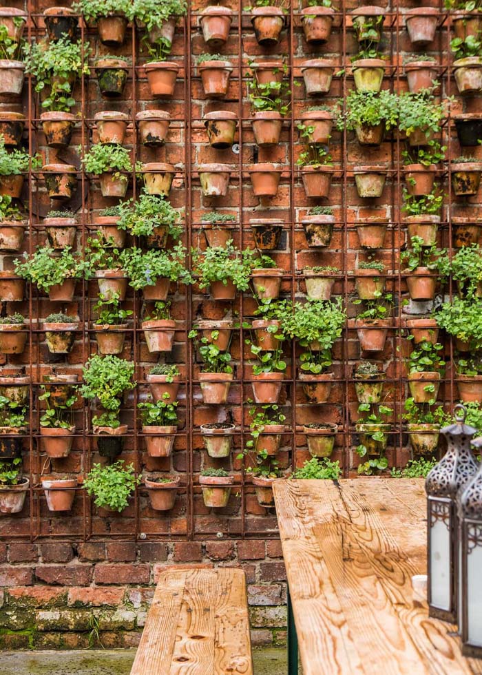 Wire Frame with Dozens of Terra Cotta Pots #gardenfencedecoration #decorhomeideas