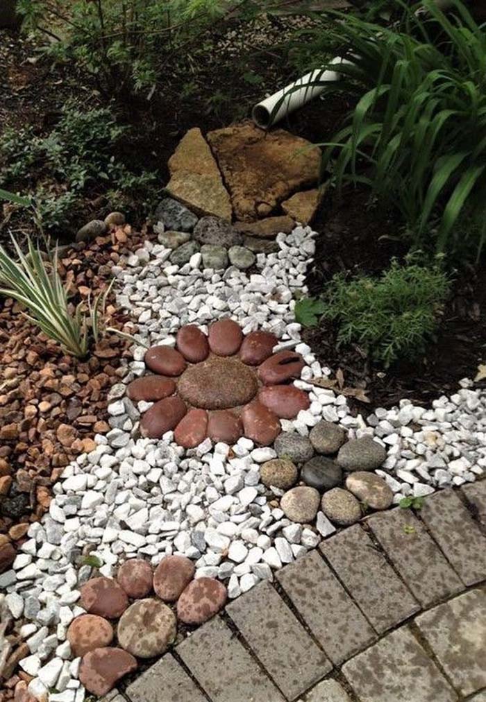 Large Flowers on Colorful Rock Bed #riverrocklandscaping #decorhomeideas