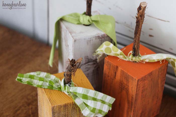 10. Distressed Painted Wood Pumpkins With Ties #cheapfalldecor #diy #decorhomeideas