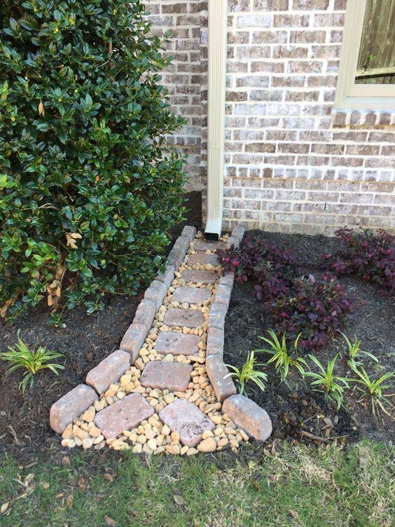 A Dry Creek With Pebbles and Old Bricks #downspout #landscaping #rocks #decorhomeideas