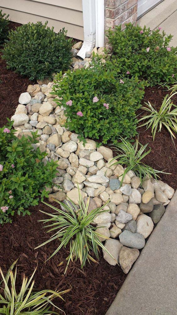 A Stunning Landscaping With Natural Stones And Green Plants #downspout #landscaping #rocks #decorhomeideas