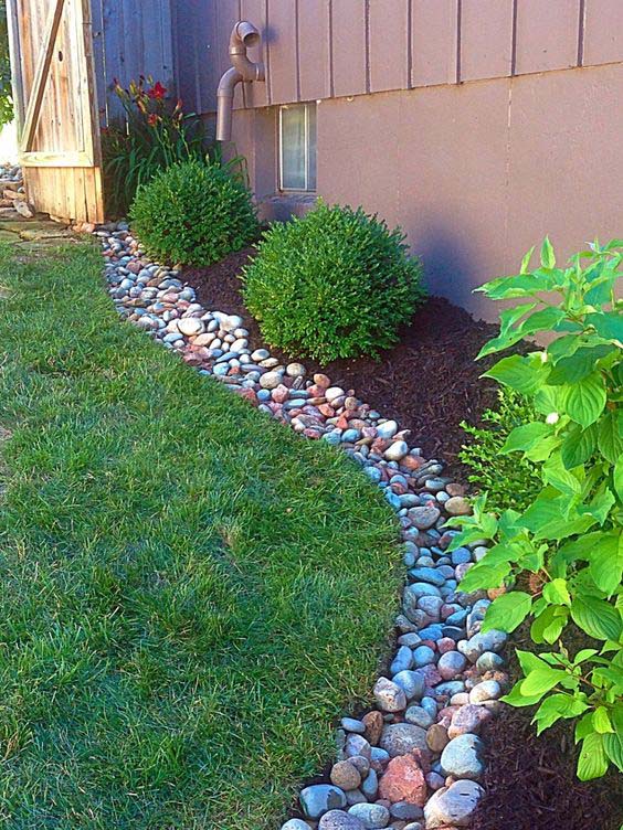 A Long Pebble Dry Creek With Plants #downspout #landscaping #rocks #decorhomeideas