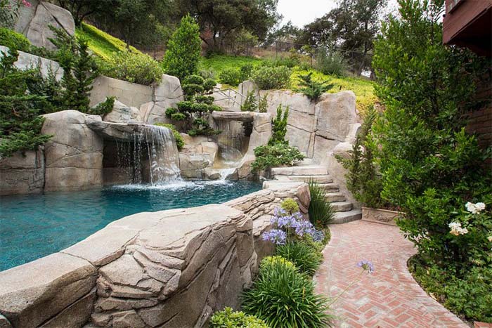 A Rocky Retreat On the Hillside #abovegroundpool #landscapingideas #decorhomeideas