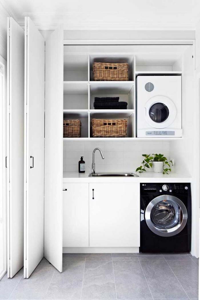 Folding Door in an All-White Laundry Closet for a Contemporary and Minimalist Look #laundry #closetdoors #decorhomeideas