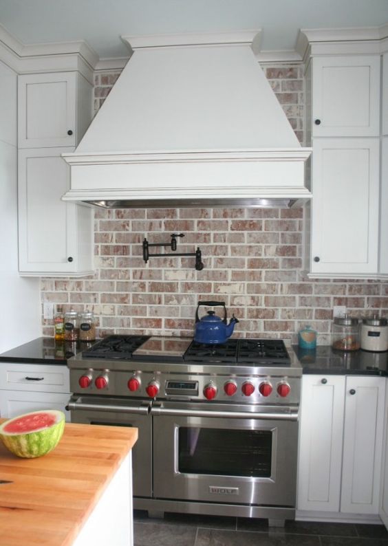 Red Brick Behind Large Range Hood #brickbacksplash #kitchen #decorhomeideas