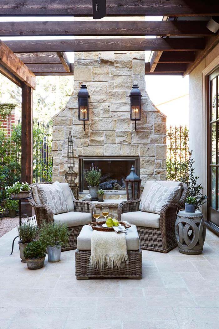 Sophisticated Wicker Arrangement by an Outdoor Fireplace #outdoorlivingspaces #decorhomeideas