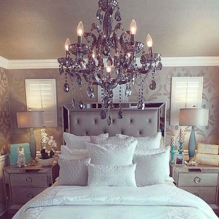 A Grey Chandelier and Satiny Bed Settings Give this Bedroom a Regal Feel #greybedroom #decorhomeideas