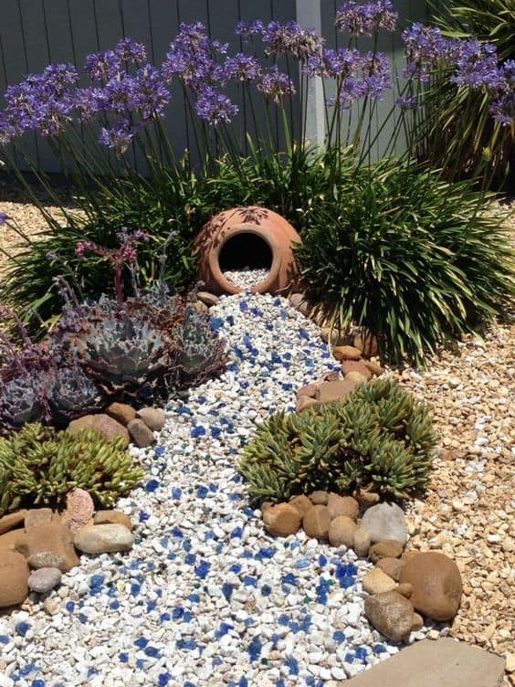 Tall Flowers and Ornamental Grasses Around a Dry Creek Bed #dryriverbed #drycreek #decorhomeideas