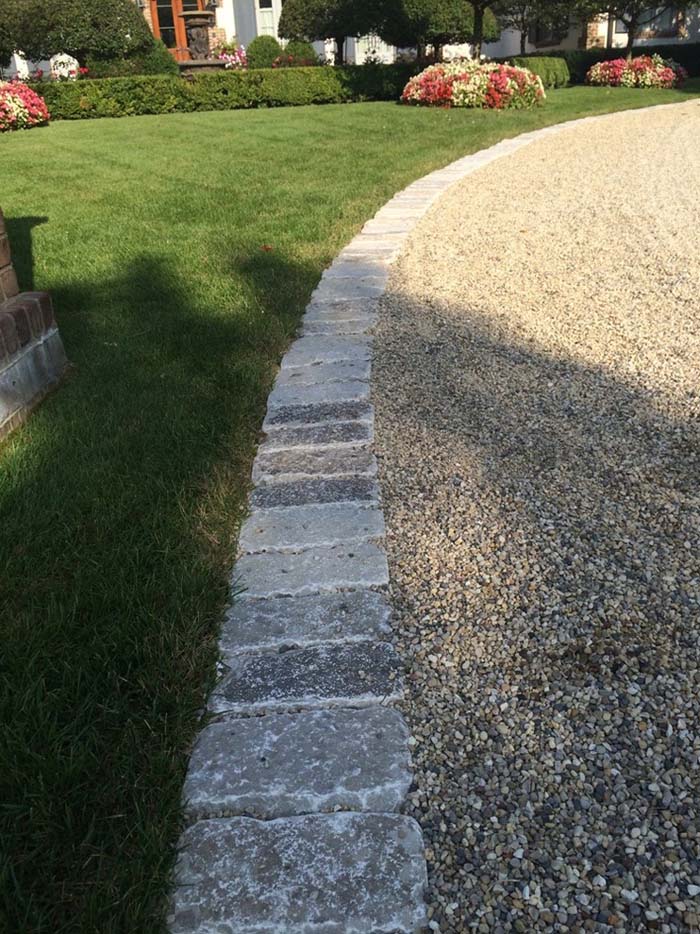 Cobbles Separate Grass From Pea Gravel