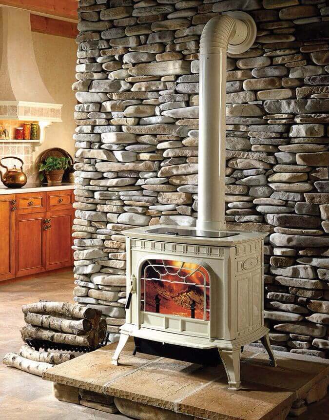 Rustic Stove In Front Of Natural Stone Wall