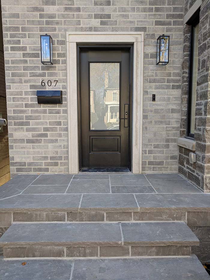 black front door grey brick house