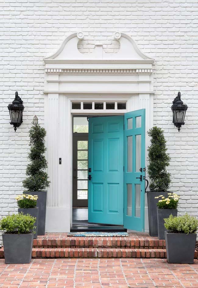 turquoise front door white brick house