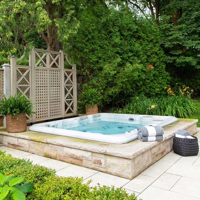 Hot Tub Landscaping Idea On A Budget With Metal Privacy Screen And Stone Lining