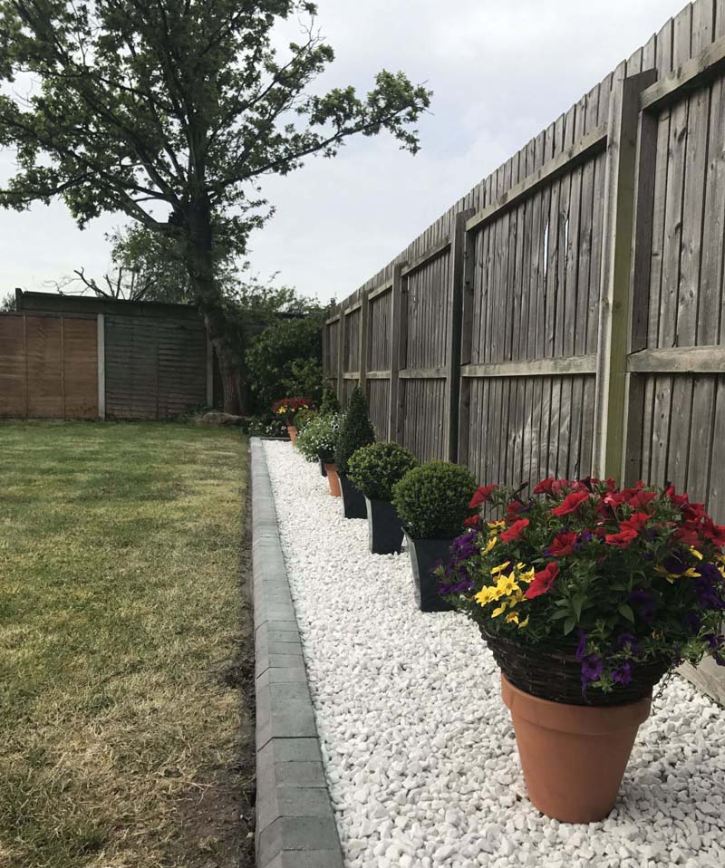 Jardim de seixos com vasos de flores