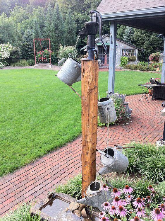 Antique Watering Can Fountain With Old Barn Beam