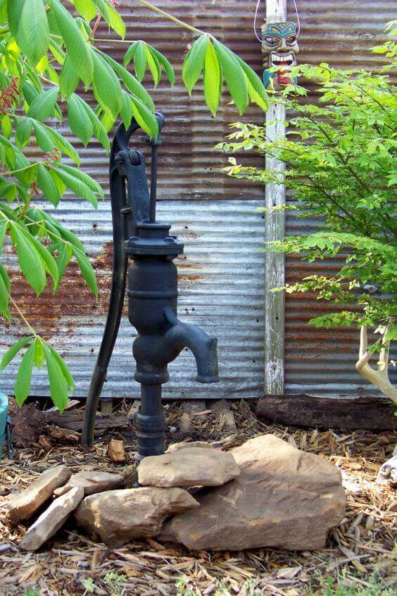 Black Old Well Pump For A Rock Garden