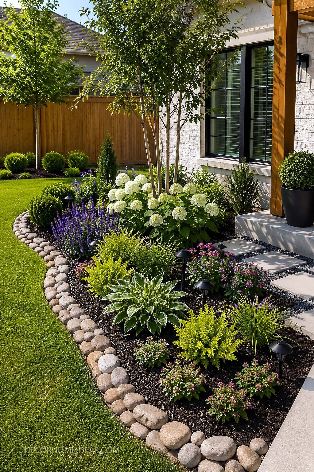 Front Yard Flower Bed With River Rock Border and White Hydrangeas
